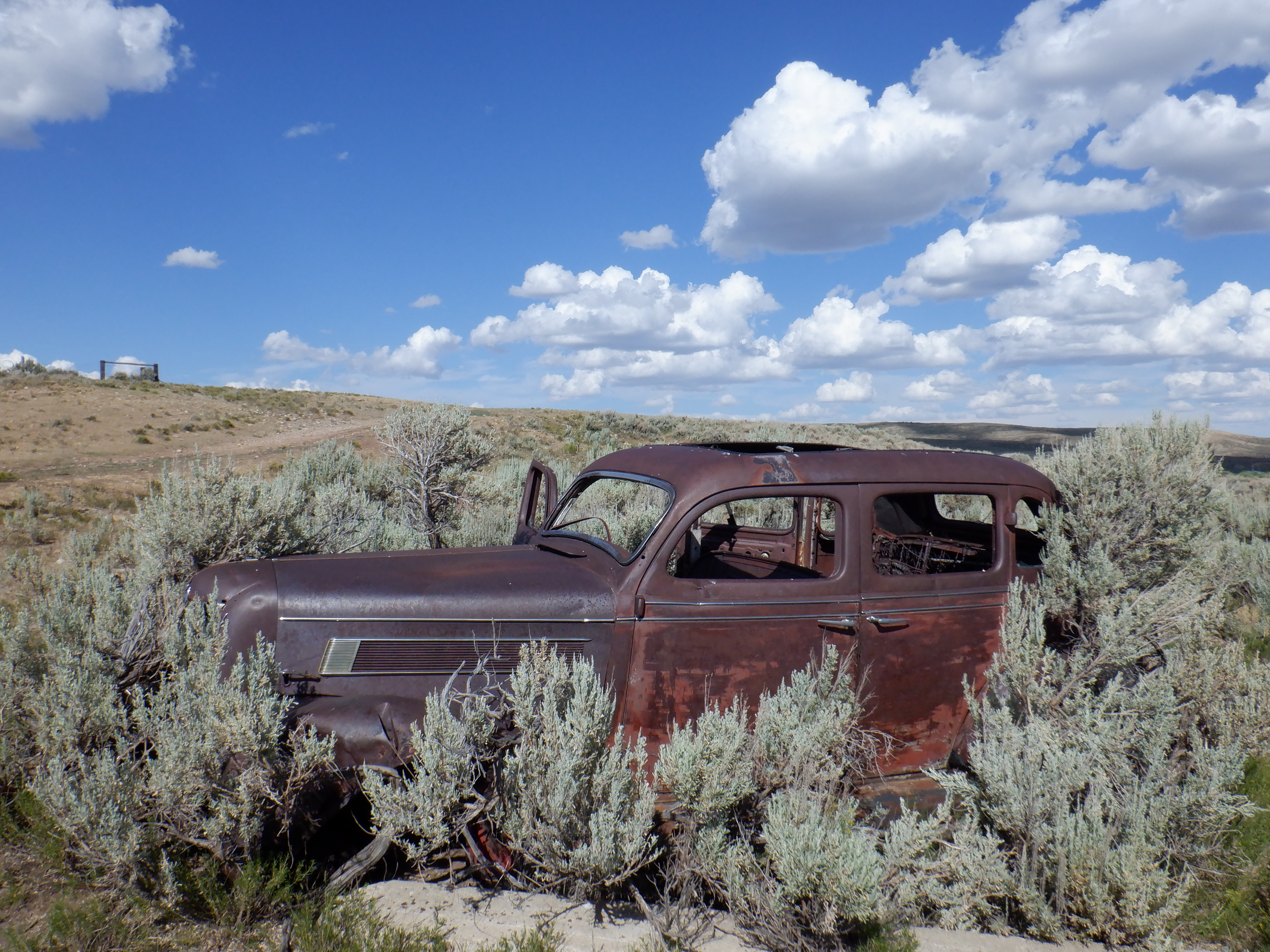 An abandoned 1930's family sedan near the river.